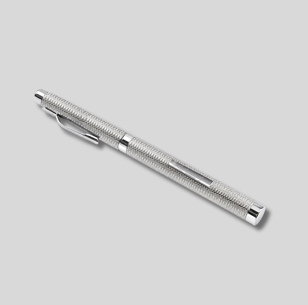 A sterling silver rollerball pen with a textured, barleycorn grip pattern and a polished clip, shown diagonally on a solid light gray background.